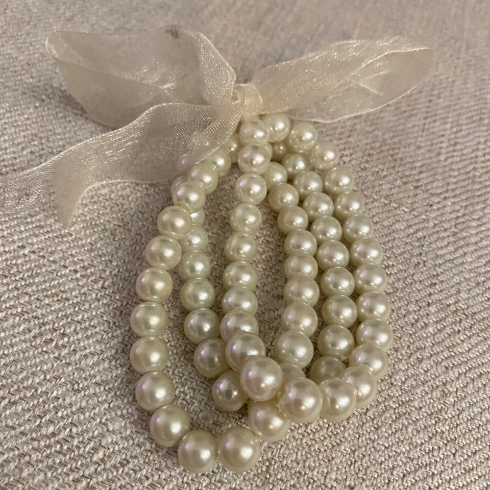 3 pearl bracelets tied together with cheer bow